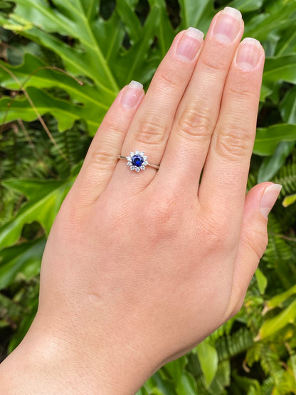 18K gold sapphire and diamond halo ring.