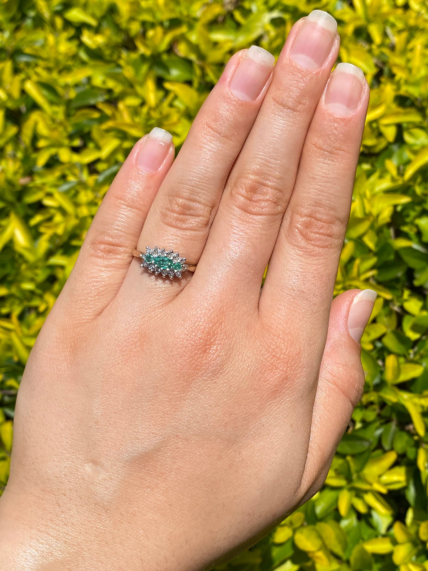 9K gold emerald and diamond ring.