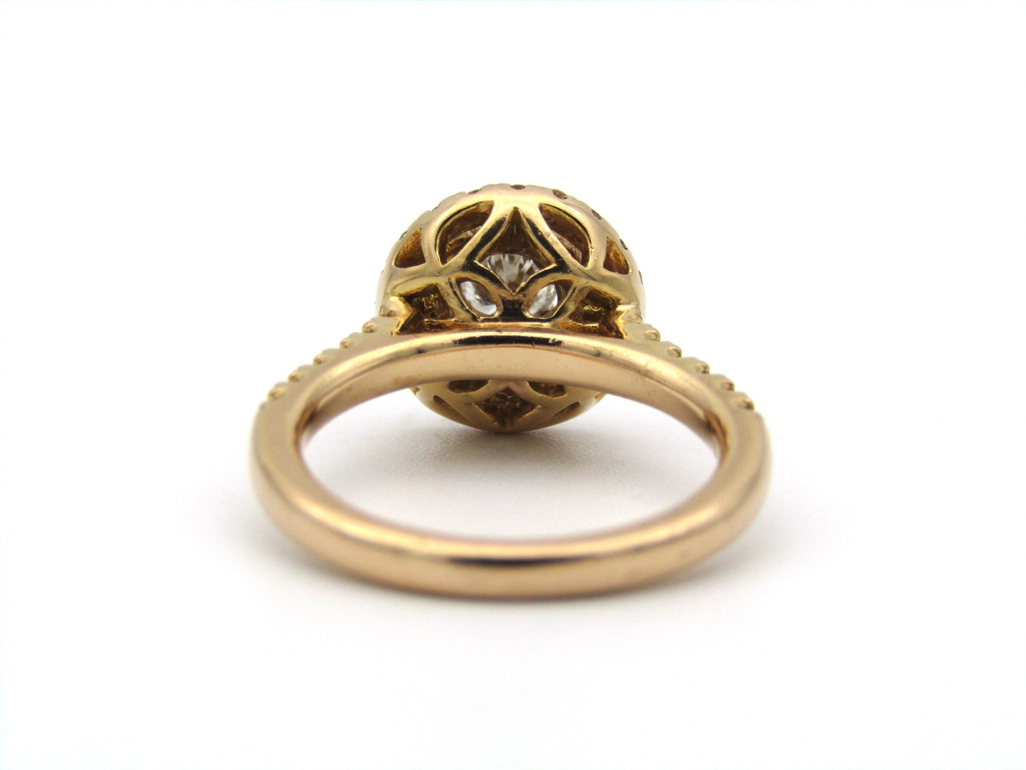 18K gold diamond halo ring.